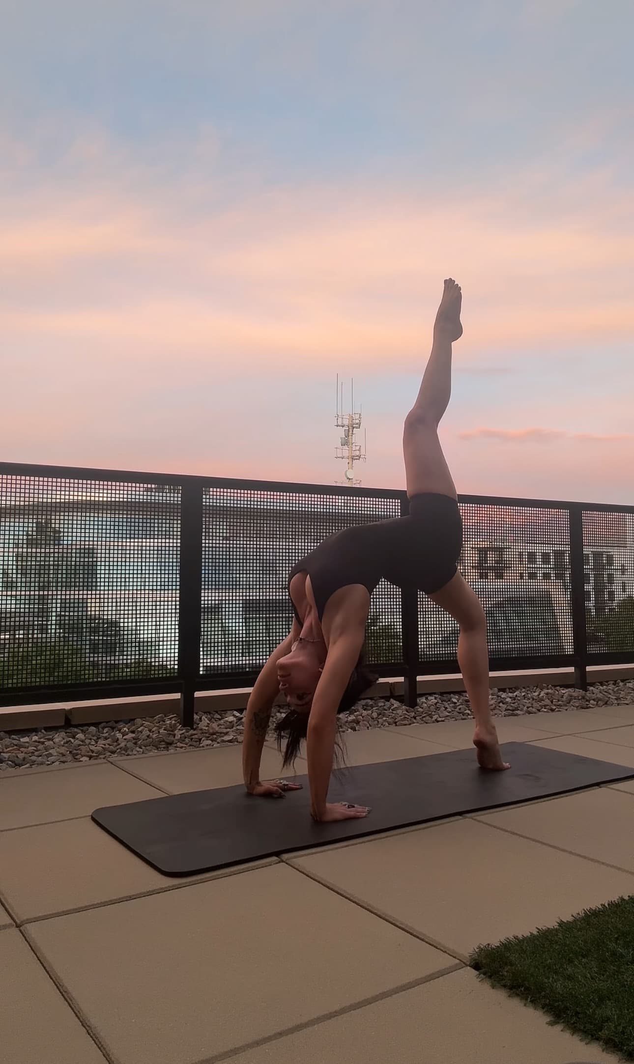 Blaire doing a handstand on a rooftop