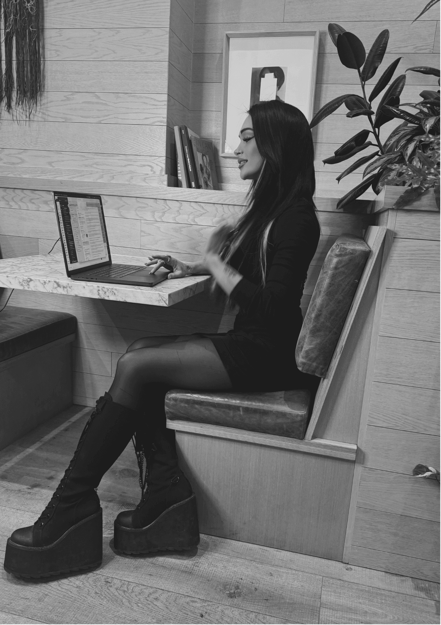 Blaire working on a laptop in black and white