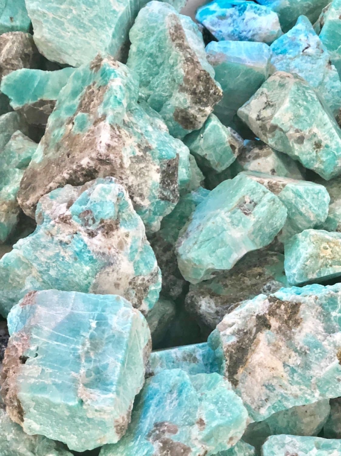 Amazonite crystal in sea-toned turquoise light with calm expressive energy.
