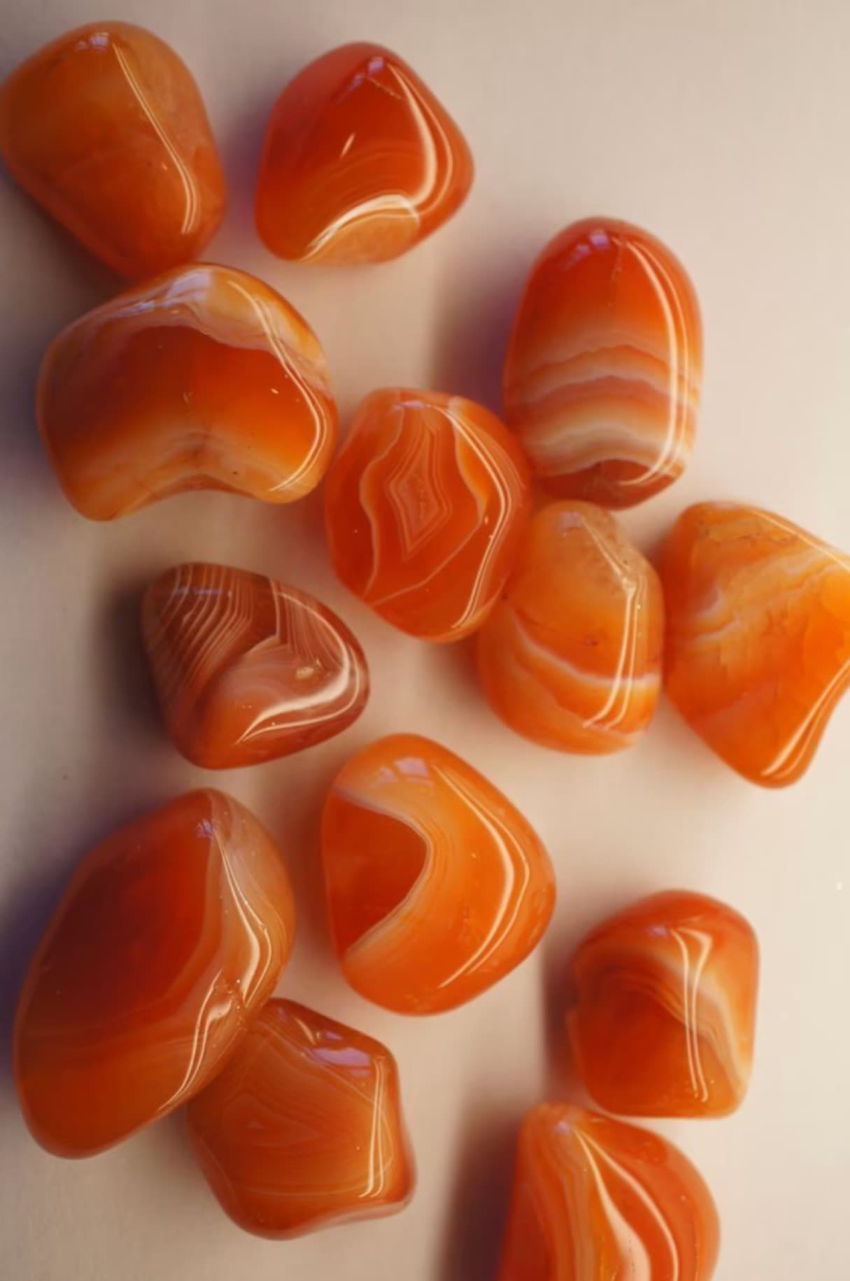 Carnelian crystal in warm orange light with bold life-force energy.