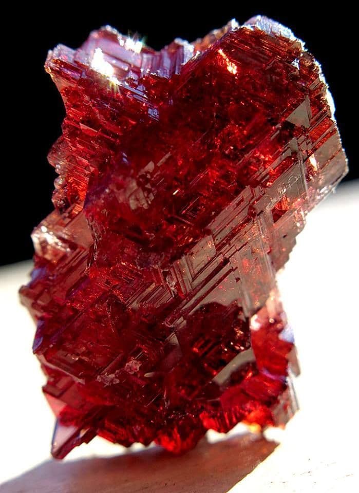 Garnet crystal in rich burgundy light with deep sensual warmth.