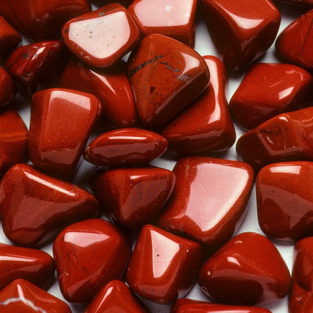 Red jasper crystal with warm earthy red tone and grounded texture.