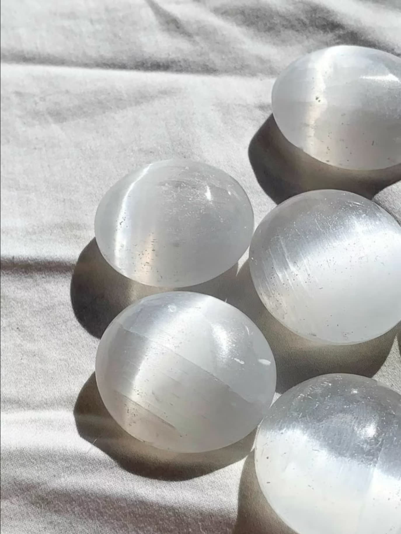 Selenite stone in airy white light with clean luminous texture.